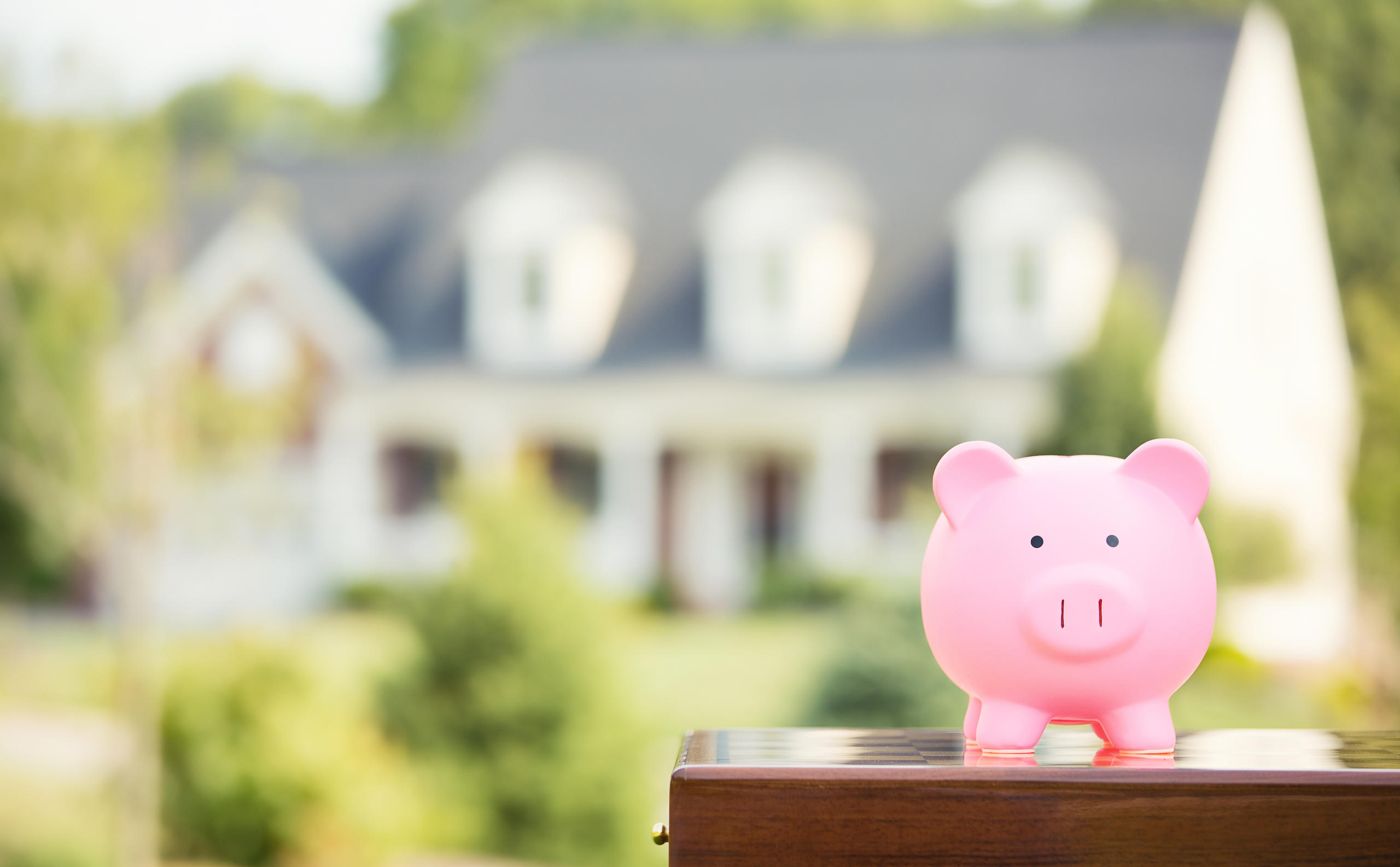 piggy bank in front of a house